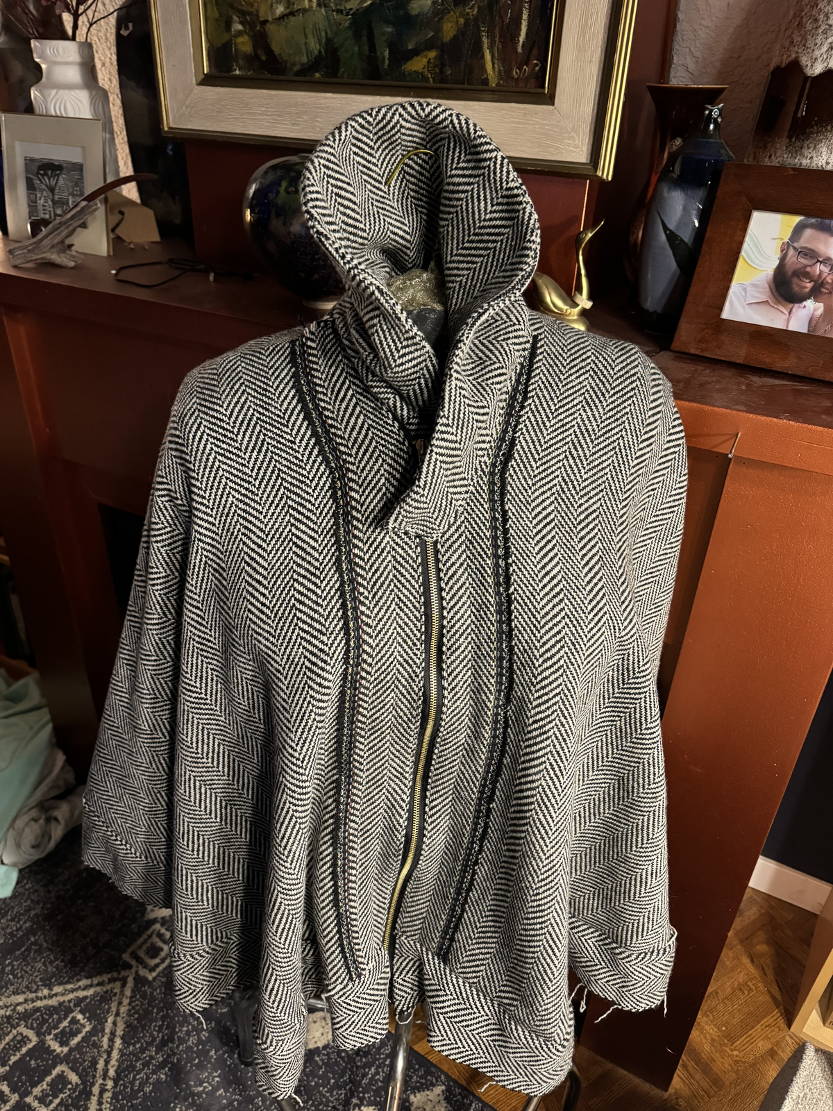 Coyote Auntie herringbone cape — front view on dress form with hood and brass zipper